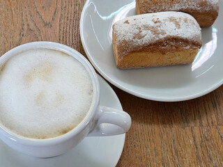 Coffee and cake. Cup with coffee and cupcake. Sweet pastries. Tasty breakfast