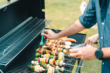 Group of diverse friend having outdoors bbq party together, camping activity lifestyle in summer, cooking fun and happy together with friends or family person group having relax in vacation time