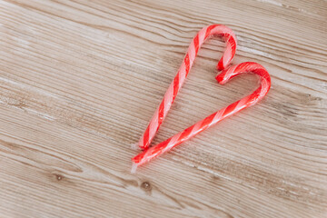 Close up heart shape sweet striped candy on the wooden table. Valentine`s day concept celebration decoration. Love, holiday, party

