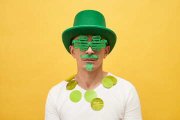 Shamrock-themed event. March festivities in Ireland. Serious funny man wearing festive green hat...