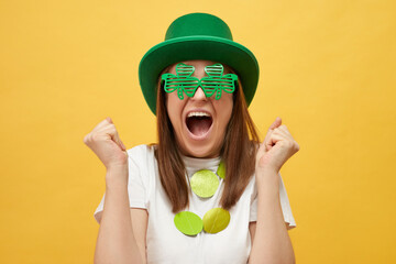Irish party in celebration of St. Patrick's Day. Happy Caucasian woman wearing green leprechaun hat...