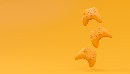 Video game joysticks or gamepads in plain monochrome yellow color background © Vasyl Onyskiv