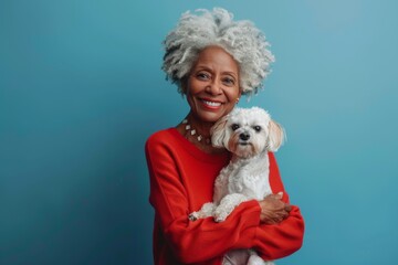 portrait of an elderly black afro american woman holding a little dog in her hands - Powered by Adobe