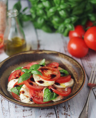 A bowl with traditional Italian caprese salad	