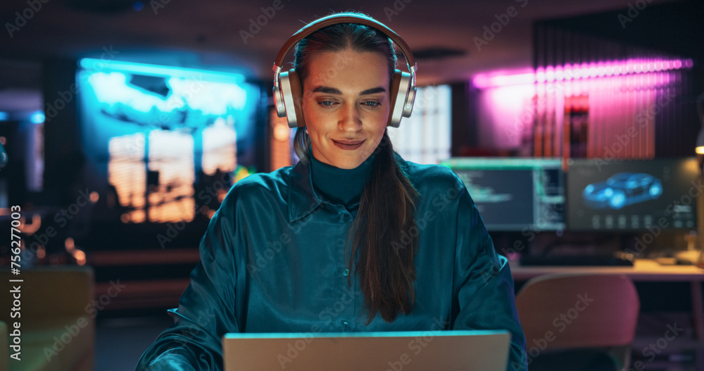 Aufkleber young project manager with headphones working on laptop computer in creative office environment. bea