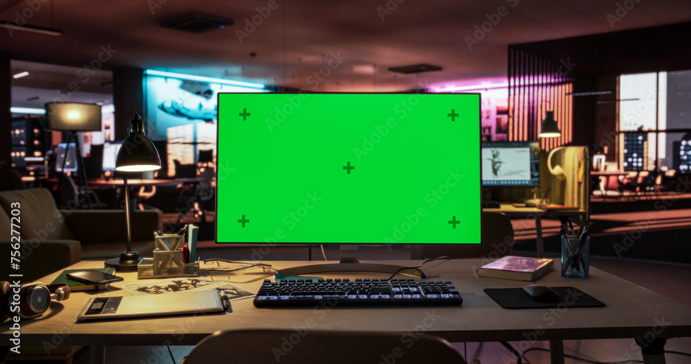 Poster Desktop Computer with Mock Up Green Screen Chroma Key Display Standing on the Desk in the Empty Creative Office Lit by Neon Lights. Monitor in Game Development or Animation Company