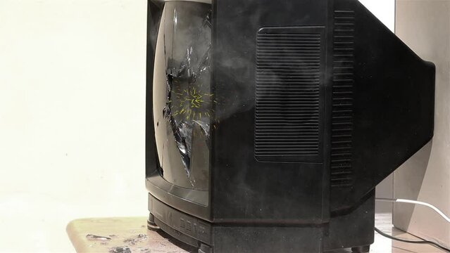 Sparks fly from the broken TV screen