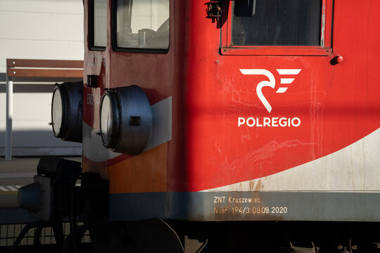Polregio logo sign, on the side of PKP class EN57 train. Polish regional rail operator logotype on old multiple unit wagon on February 15, 2024 in Krakow, Poland.