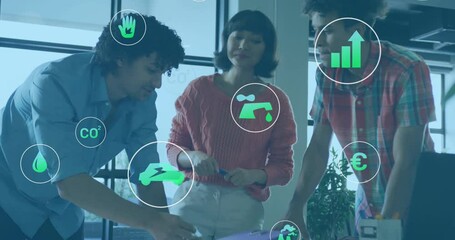 Animation of ecology icons over diverse colleagues talking in office - Powered by Adobe