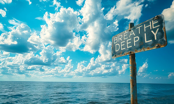 Inspirational black sign against a cloudy sky with BREATHE DEEPLY in white letters encouraging mindfulness and stress reduction