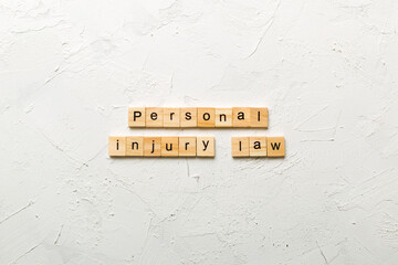 personal injury law word written on wood block. personal injury law text on table, concept