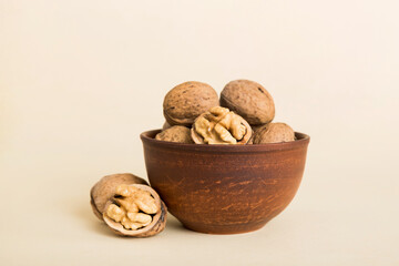 Fresh healthy walnuts in bowl on colored table background. Top view Healthy eating bertholletia concept. Super foods