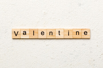 valentine word written on wood block. valentine text on table, concept
