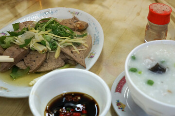 Close up bowl of Rice Congee porridge served with Scalding Liver pork