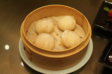 Close up Chinese 'Har Gow' Dim Sum, Steamed dumplings filled with minced pork, shrimp or others served in wooden basket container