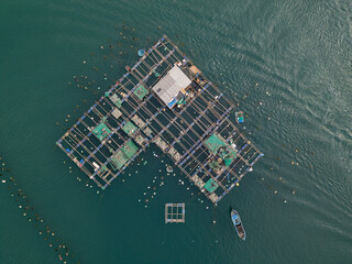 Top down aerial drone shot of floating aquaculture fish farm in Vung Ro Bay on Vietnam's South China Sea coast