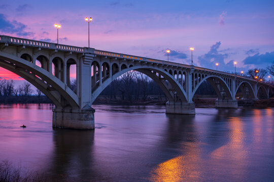 The sunsets behind the Lincoln Memorial Bridge spanning the Wabash River in Vincennes, Indiana