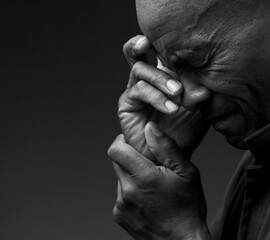 black man praying to god with hands together Caribbean man praying on black background with people stock photos stock photo	