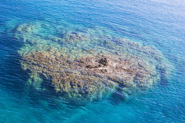 Aerial view of the rocks under the crystal clear blue sea. Mediterranean sea, Cirali, Antalya Province in Turkey.