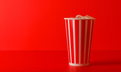 Paper cup with cola and ice over red background - 756304829