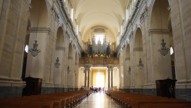 People entering the nave of a church to pray 