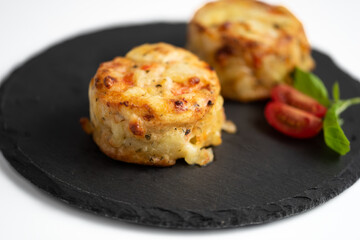 Potatoes with delicate herbs, tomatoes and soufflé, baked potatoes