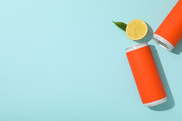 Tin can and lemon on blue background, space for text - obrazy, fototapety, plakaty