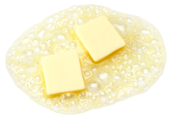 Two pieces of butter melting isolated