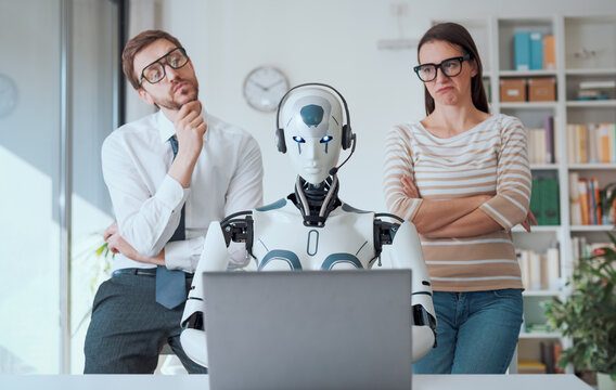 Business people supervising a robot work