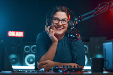 Cheerful radio DJ hosting a radio show