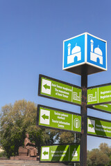 Tourist signpost in Samarkand displays directions to key landmarks like Amir Temur's mausoleum and...