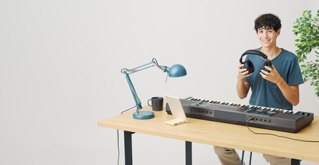 Adolescent playing the keyboard at home