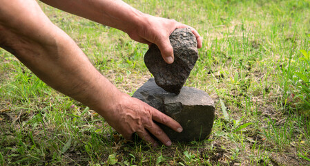 Hands of primitive man with stone