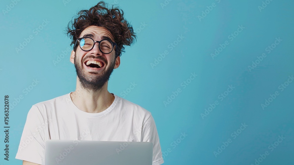 Poster Millennial guy in glasses using laptop computer for online work or communicating against blue studio background