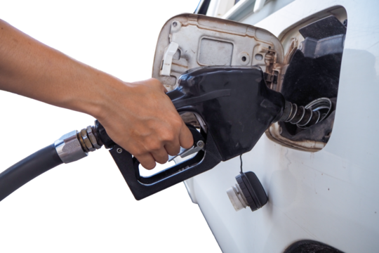 Hand pumps gasoline into car at station