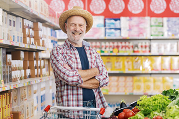Confident farmer doing grocery shopping at the supermarket