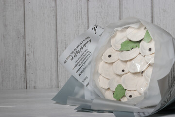 Bouquet of marshmallow dumplings. Marshmallow dumplings. Homemade marshmallows. on a white wooden background. Place for text.