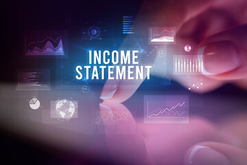 Finger touching tablet with business graphs and icons concept