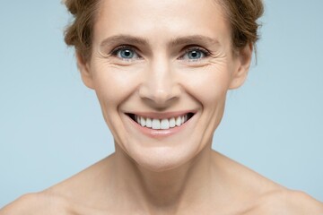 Beauty portrait of middle-age woman with perfect and shiny skin. Concept of skin care and aesthetic cosmetology