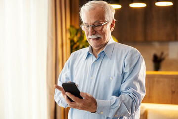 Portrait of a senior man using modern technologies.