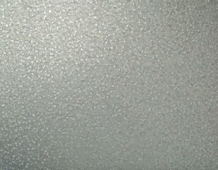 A detailed view of galvanized zinc with its distinctive crystalline surface pattern, known as spangle, under soft lighting.