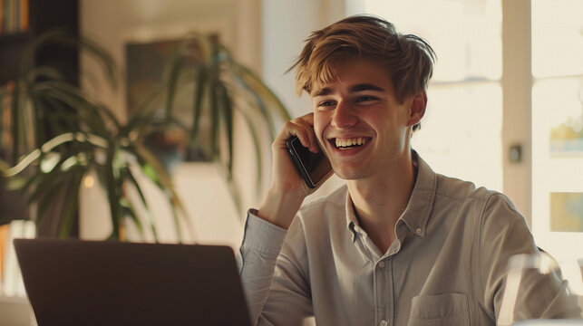 A young man smiles warmly while making a phone call and using a laptop in his home office. With a bright and neatly arranged room in the background, Ai generated Images