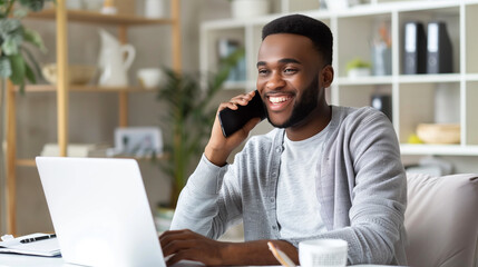 A young man smiles warmly while making a phone call and using a laptop in his home office. With a bright and neatly arranged room in the background, Ai generated Images