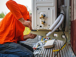 Air conditioning technicians install new compressor air in homes, Repairman fix air conditioning...