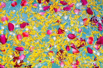 Water with jasmine flower, marigold petals and rose petals in bowl. Thai tradition, Songkran Festival