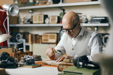 Business owner checking vintage items in his shop