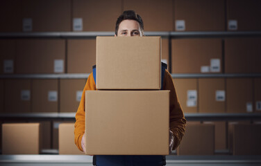 Warehouse worker holding delivery boxes