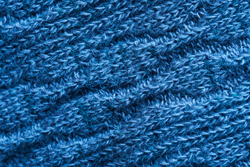 Warm and cozy blue textile wool material - fabric. Background or backdrop. Diagonal fibers. Photo. Macro