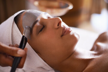 Woman, relax and mask in spa for skincare, beauty and cosmetic treatment for break or peace. Young person and natural for holistic therapy for wellness, clean and hygiene with product for facial