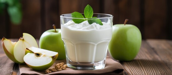 A refreshing dish of yogurt with green apples served on a rustic wooden table. A perfect blend of fruit, dairy, and plantbased goodness - Powered by Adobe
